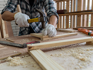 Carpenter working on wood craft at workshop